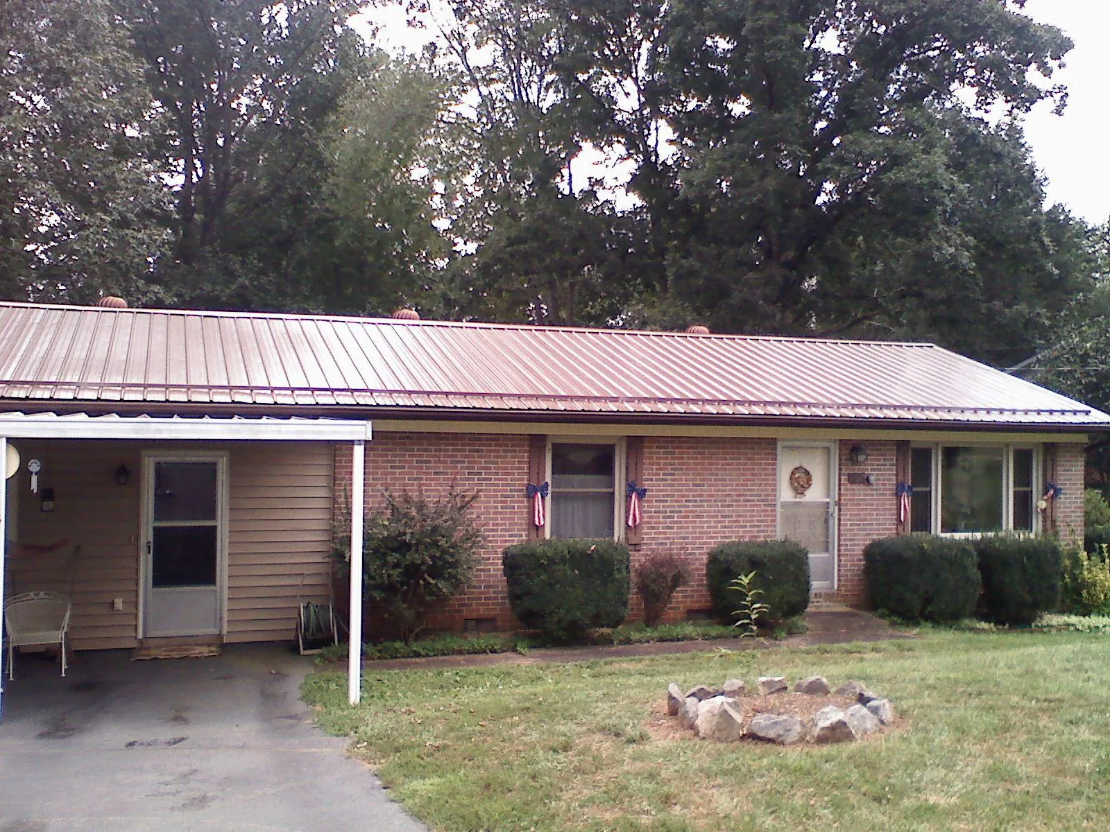 Bronze metal roof and carport on a brick ranch home — Roof Repair work by our crew in Vantage